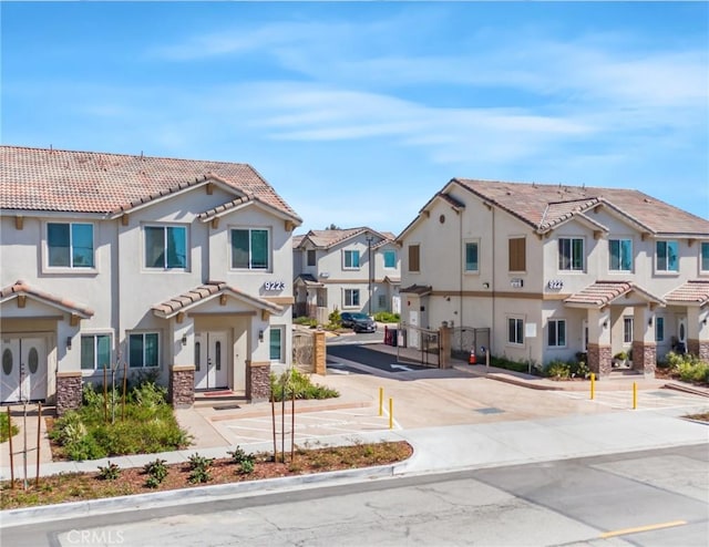 view of street featuring sidewalks, curbs, and a residential view