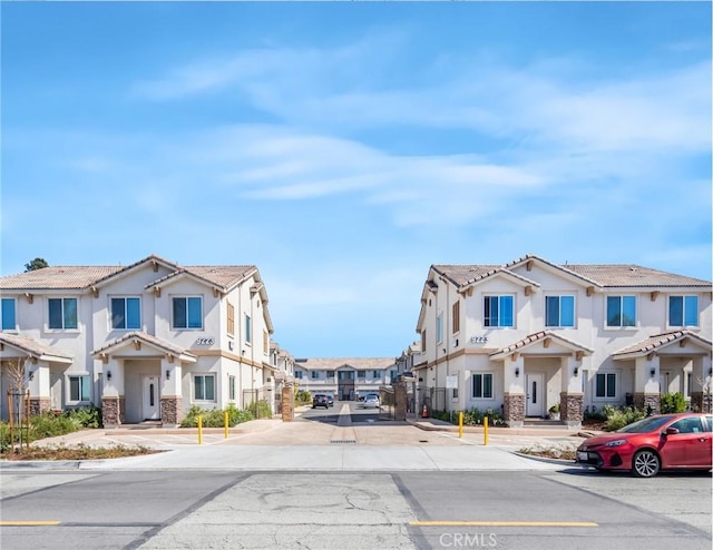 view of road featuring sidewalks, a residential view, and curbs