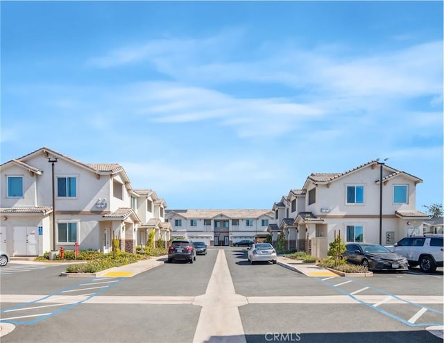 view of road with a residential view, curbs, and sidewalks