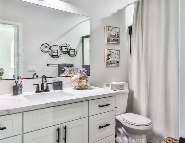 bathroom featuring toilet and vanity