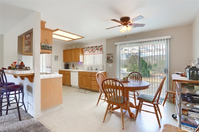 dining area with a ceiling fan and light floors