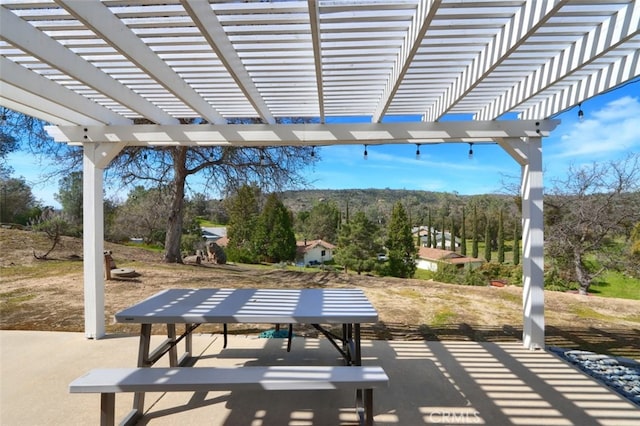 view of property's community featuring a patio area and a pergola