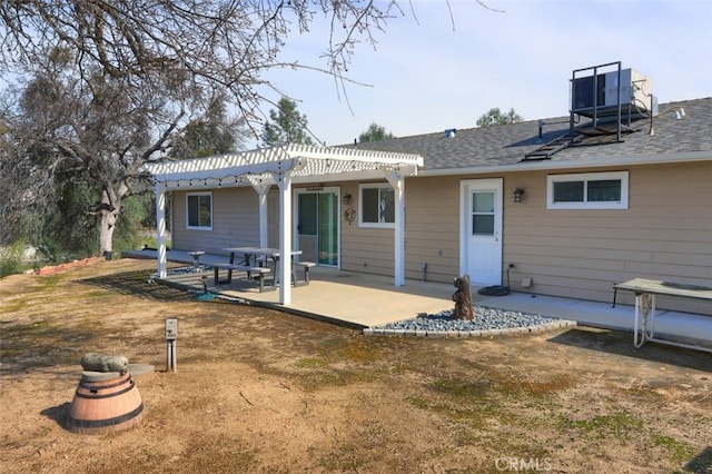 back of house with a patio, a pergola, and a shingled roof