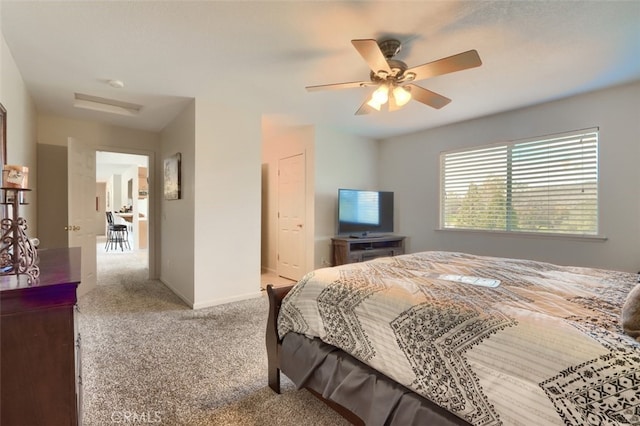 bedroom with ceiling fan, baseboards, and carpet