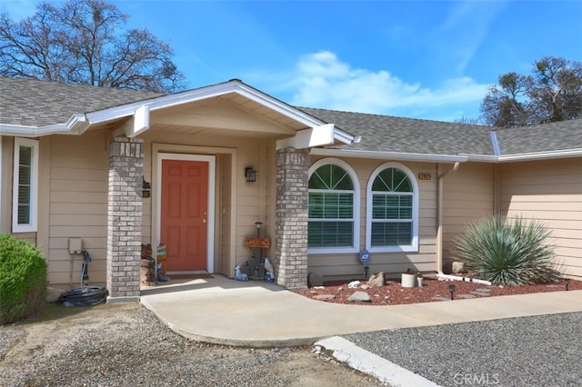 property entrance with roof with shingles