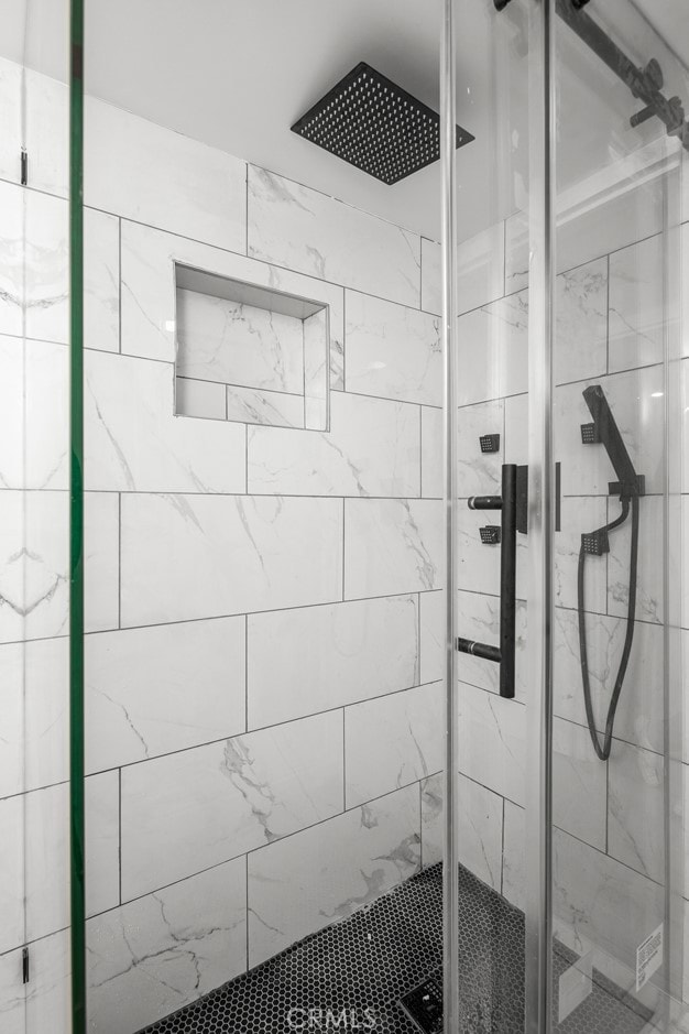 bathroom featuring a shower stall