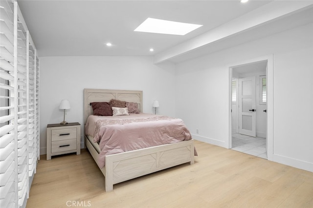 bedroom with light wood finished floors, recessed lighting, and a skylight