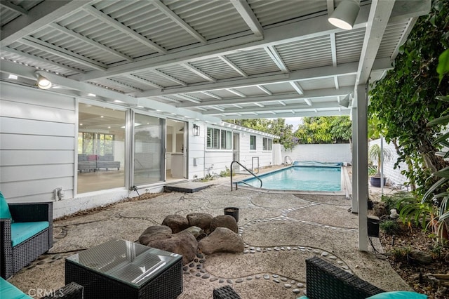 view of pool with a patio area, a fenced in pool, and fence