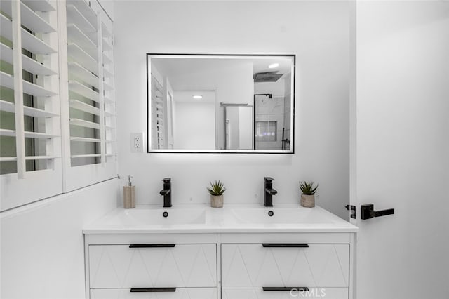 bathroom with a sink, double vanity, and a shower stall