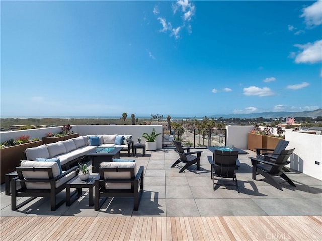 view of patio / terrace with an outdoor living space with a fire pit and a mountain view