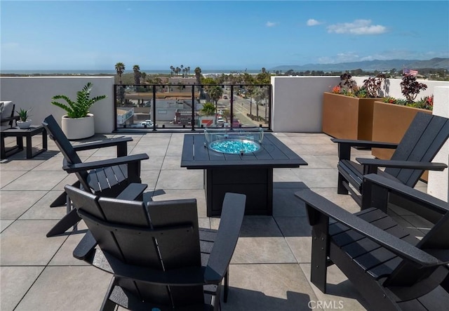 view of patio / terrace featuring a mountain view and an outdoor fire pit