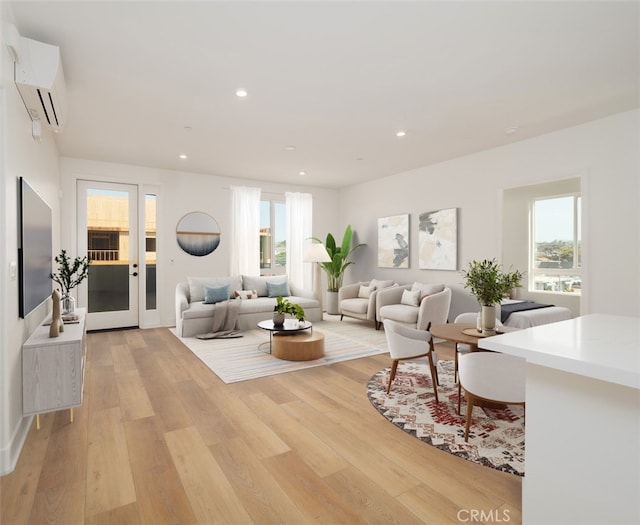 living room featuring a wealth of natural light, light wood-style floors, and a wall unit AC