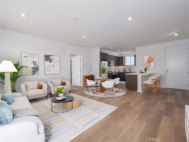 living area featuring recessed lighting and light wood-style flooring