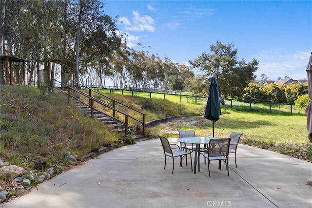 view of patio with outdoor dining space and fence