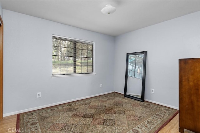 unfurnished room featuring baseboards