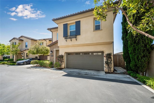 3242 Harmona Pl, Los Alamitos, CA 90720 - mediterranean / spanish home with fence, stucco siding, a tiled roof, an attached garage, and driveway
