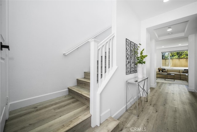 3242 Harmona Pl, Los Alamitos, CA 90720 - staircase with baseboards, recessed lighting, a raised ceiling, and wood finished floors