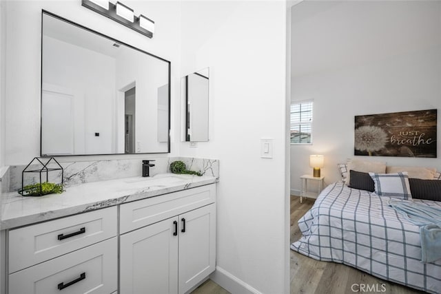3242 Harmona Pl, Los Alamitos, CA 90720 - bedroom with a sink, baseboards, and light wood finished floors