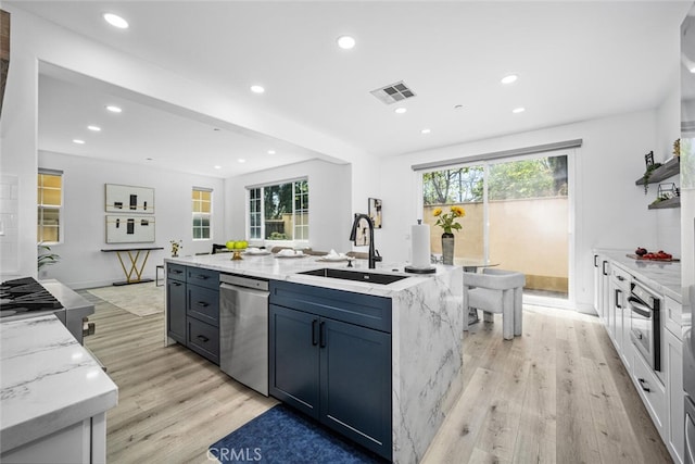3242 Harmona Pl, Los Alamitos, CA 90720 - kitchen with visible vents, a center island with sink, dishwasher, a sink, and light wood-style flooring