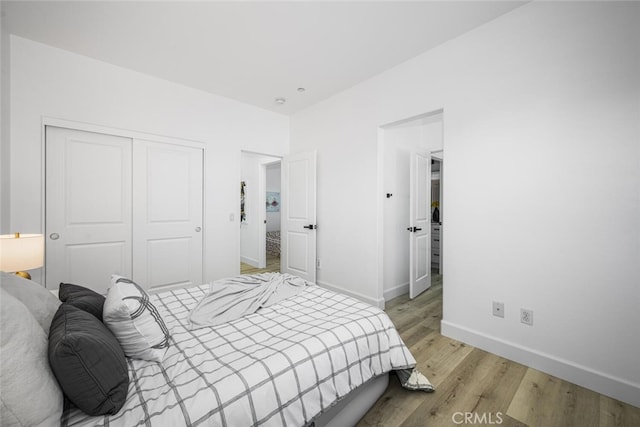 3242 Harmona Pl, Los Alamitos, CA 90720 - bedroom with a closet, baseboards, and light wood-style floors
