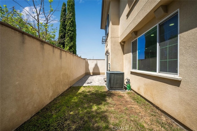 3242 Harmona Pl, Los Alamitos, CA 90720 - view of home's exterior featuring a patio, central AC unit, a fenced backyard, and stucco siding