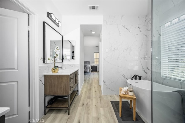 3242 Harmona Pl, Los Alamitos, CA 90720 - ensuite bathroom with vanity, visible vents, wood finished floors, and ensuite bath