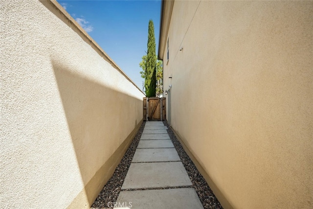 3242 Harmona Pl, Los Alamitos, CA 90720 - view of side of property with a gate and stucco siding