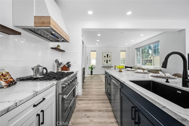 3242 Harmona Pl, Los Alamitos, CA 90720 - kitchen featuring a sink, premium range hood, light wood finished floors, stainless steel appliances, and recessed lighting