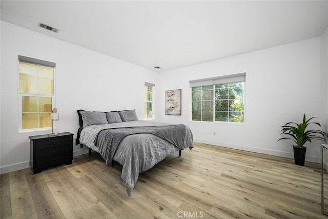 3242 Harmona Pl, Los Alamitos, CA 90720 - bedroom featuring baseboards, visible vents, and light wood-style floors