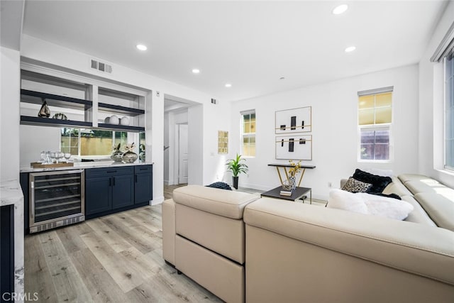 3242 Harmona Pl, Los Alamitos, CA 90720 - living area with light wood-style flooring, indoor wet bar, recessed lighting, wine cooler, and visible vents