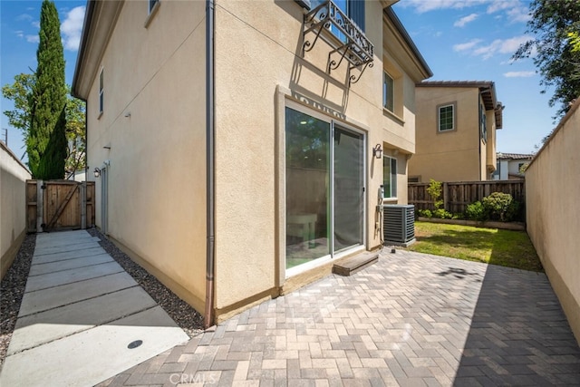 3242 Harmona Pl, Los Alamitos, CA 90720 - view of side of property featuring stucco siding, a gate, a fenced backyard, and a patio area