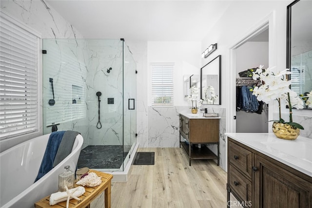 3242 Harmona Pl, Los Alamitos, CA 90720 - bathroom featuring a freestanding bath, a marble finish shower, vanity, and wood finished floors