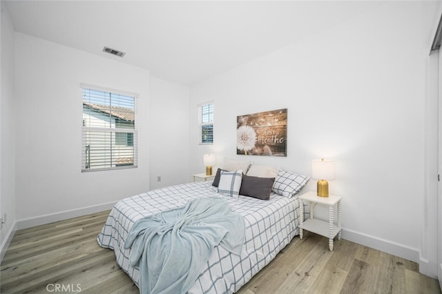 3242 Harmona Pl, Los Alamitos, CA 90720 - bedroom with light wood-style floors, baseboards, and visible vents