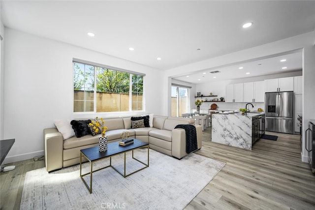 3242 Harmona Pl, Los Alamitos, CA 90720 - living room with baseboards, recessed lighting, and light wood-style flooring