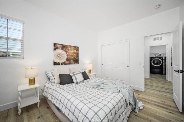 3242 Harmona Pl, Los Alamitos, CA 90720 - bedroom with wood finished floors, a closet, washer / clothes dryer, and visible vents