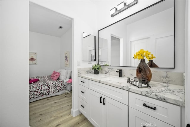 3242 Harmona Pl, Los Alamitos, CA 90720 - ensuite bathroom featuring vanity, ensuite bath, wood finished floors, and visible vents
