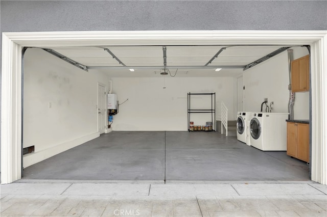 garage featuring separate washer and dryer and tankless water heater