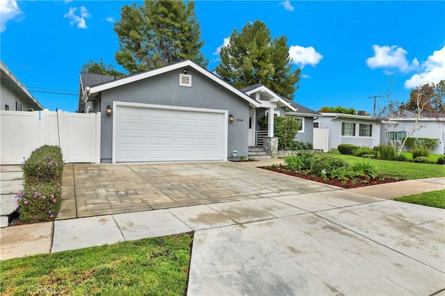 single story home with stucco siding, a front lawn, driveway, fence, and an attached garage