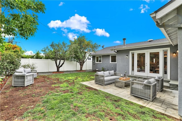 view of yard with a patio area, french doors, outdoor lounge area, and a fenced backyard