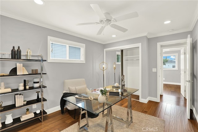 office area with a ceiling fan, crown molding, wood finished floors, and baseboards