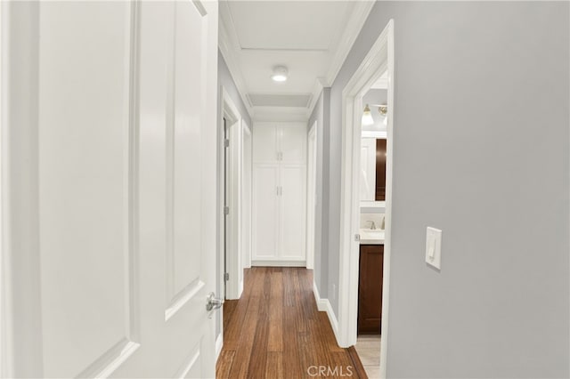 corridor with attic access and wood finished floors