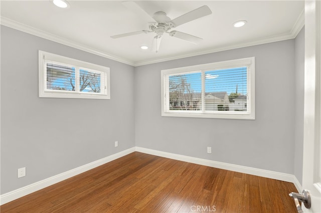 spare room with wood finished floors, recessed lighting, crown molding, baseboards, and ceiling fan