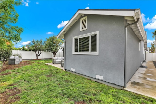 view of home's exterior featuring stucco siding, a lawn, a patio, a fenced backyard, and crawl space