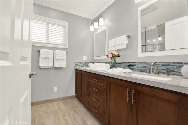 bathroom with vanity, baseboards, backsplash, and ornamental molding