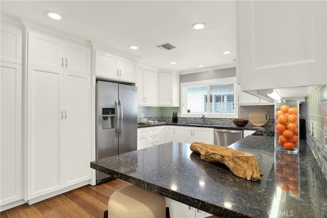 kitchen featuring a sink, visible vents, appliances with stainless steel finishes, and white cabinets