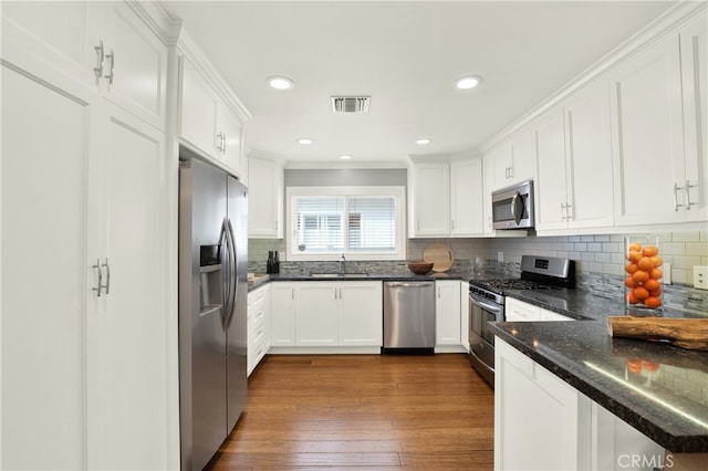 kitchen featuring a sink, white cabinets, visible vents, and stainless steel appliances