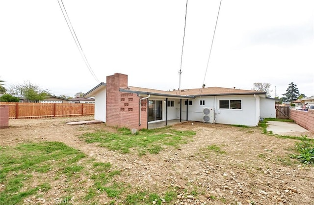 back of house featuring a fenced backyard