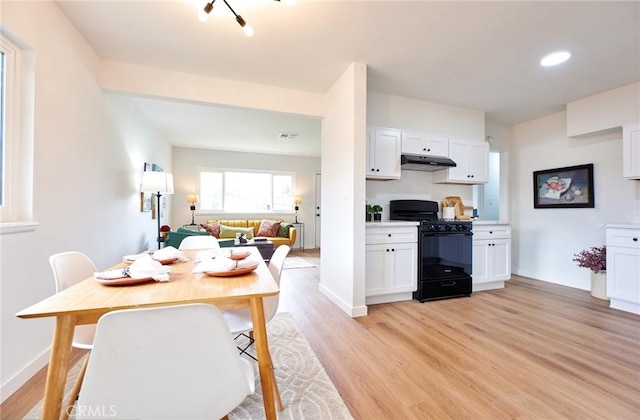 dining area with visible vents, baseboards, and light wood-style floors