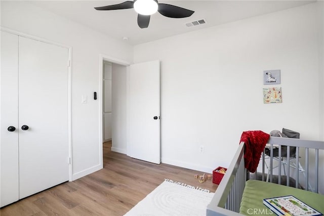 bedroom featuring wood finished floors, baseboards, and ceiling fan