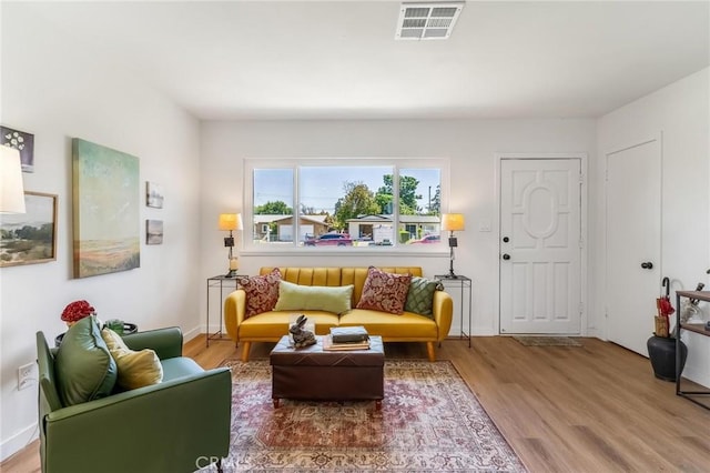 living area featuring wood finished floors and baseboards